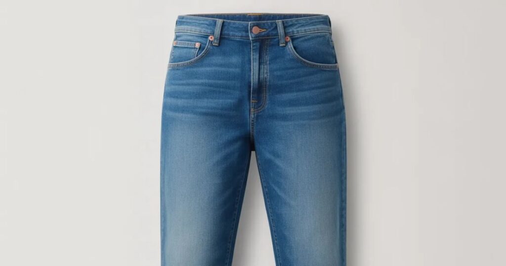 Side profile of mid rise jeans showing slim fit and clean pocket lines.