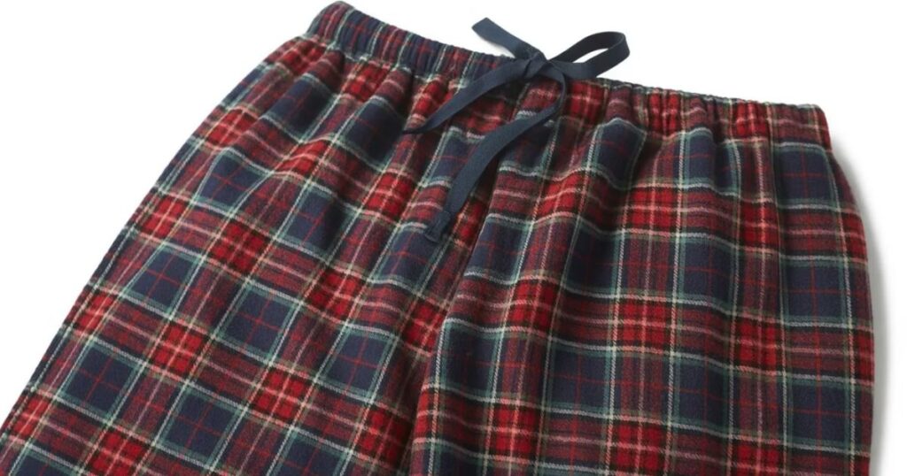 Cozy plaid pyjama bottoms styled with a plain sleep top for home wear